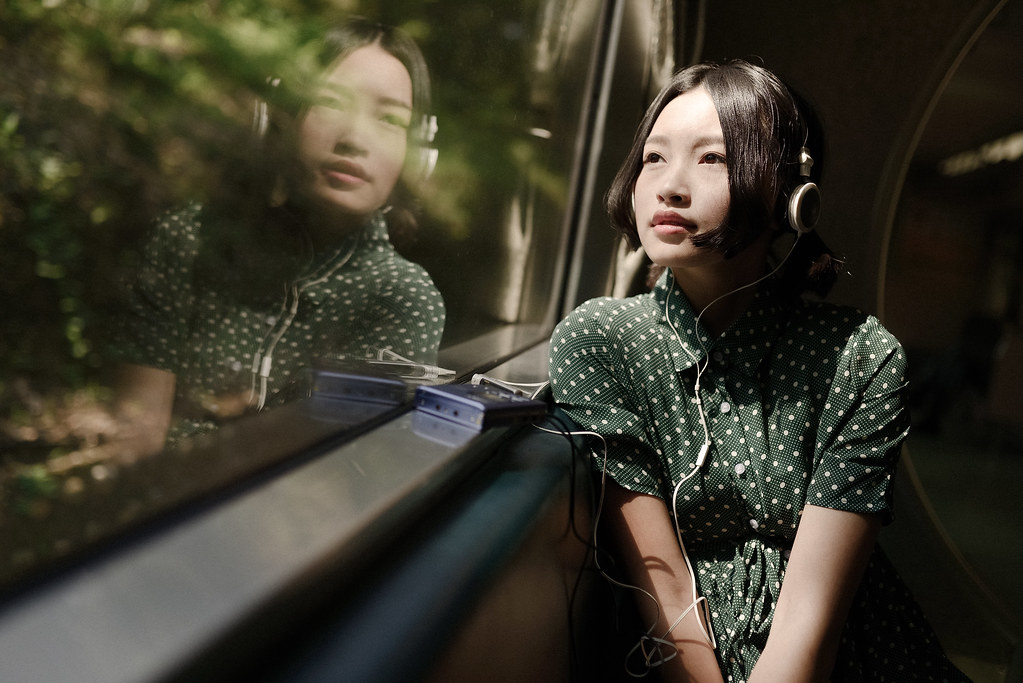 Photo of girl listening to music on a train